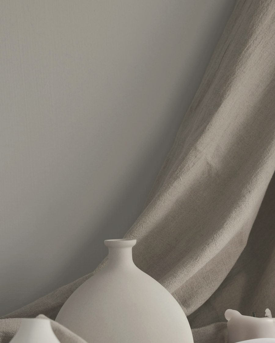 Handmade ivory ceramics against a linen drape