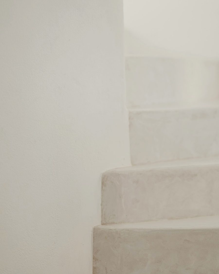 Limewashed plaster steps in soft coastal light